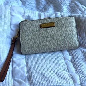 Michael Kors cream and tan leather wristlet in good condition